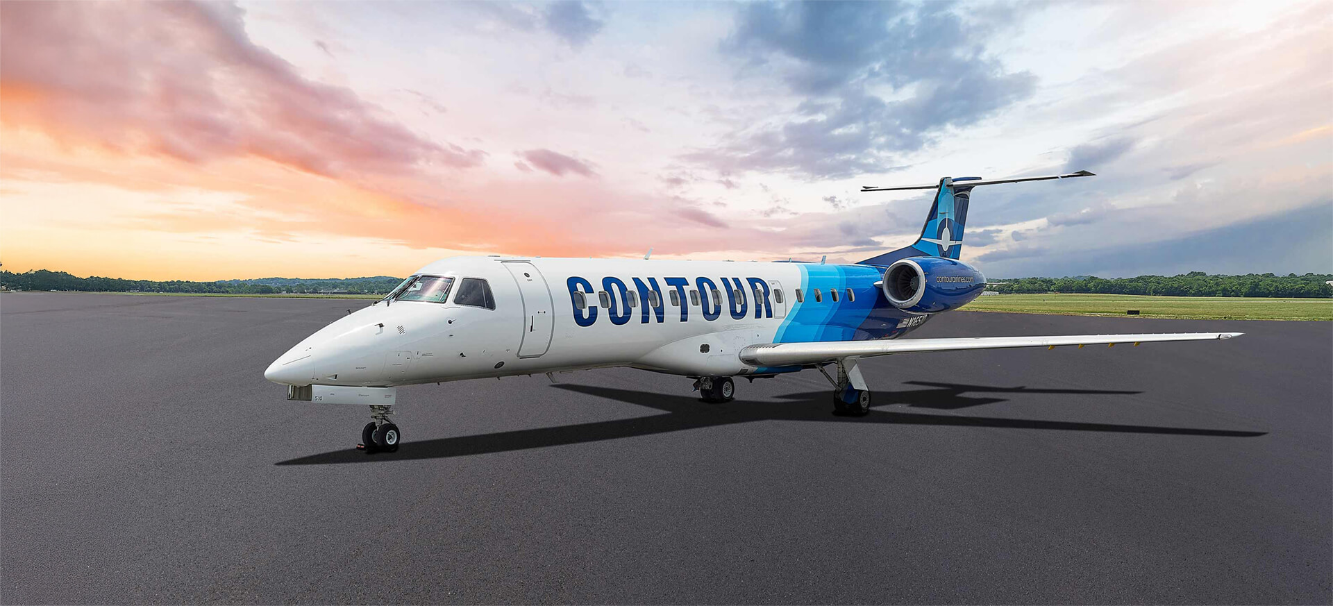 A Contour Airlines plane sits on a tarmac, backlit by a calm sunrise.